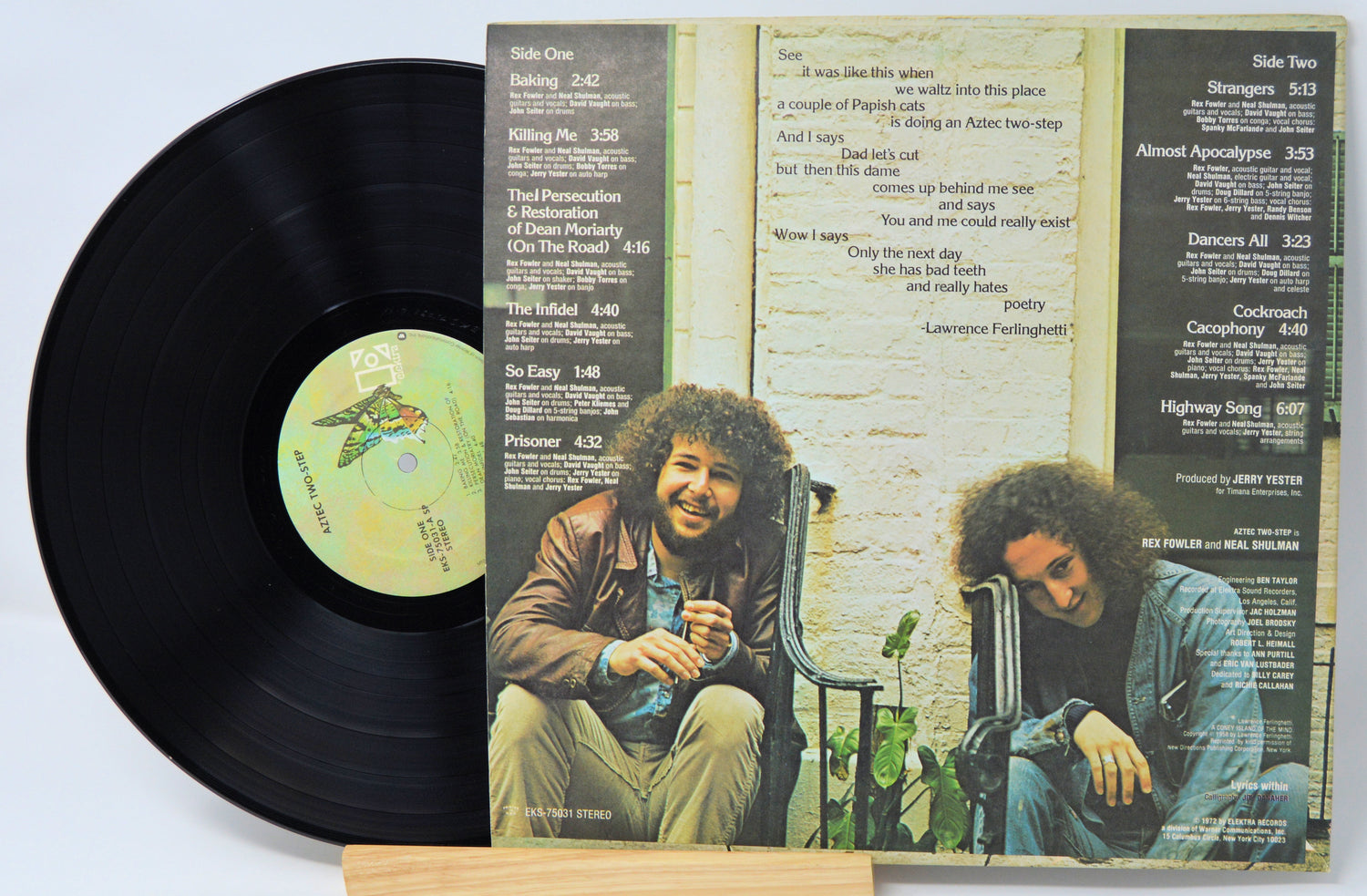 Vinyl record with cover featuring two people sitting on a bench.