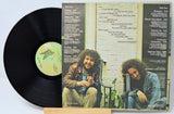 Vinyl record with cover featuring two people sitting on a bench.