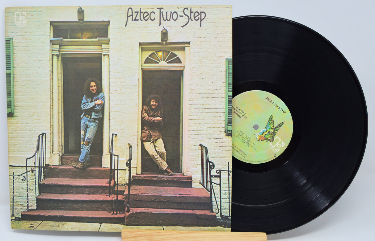 Vinyl record with cover featuring two people on a porch, titled 'Aztec Two-Step'.
