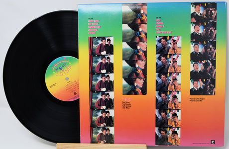 Vinyl record with a colorful cover featuring multiple images of a person.