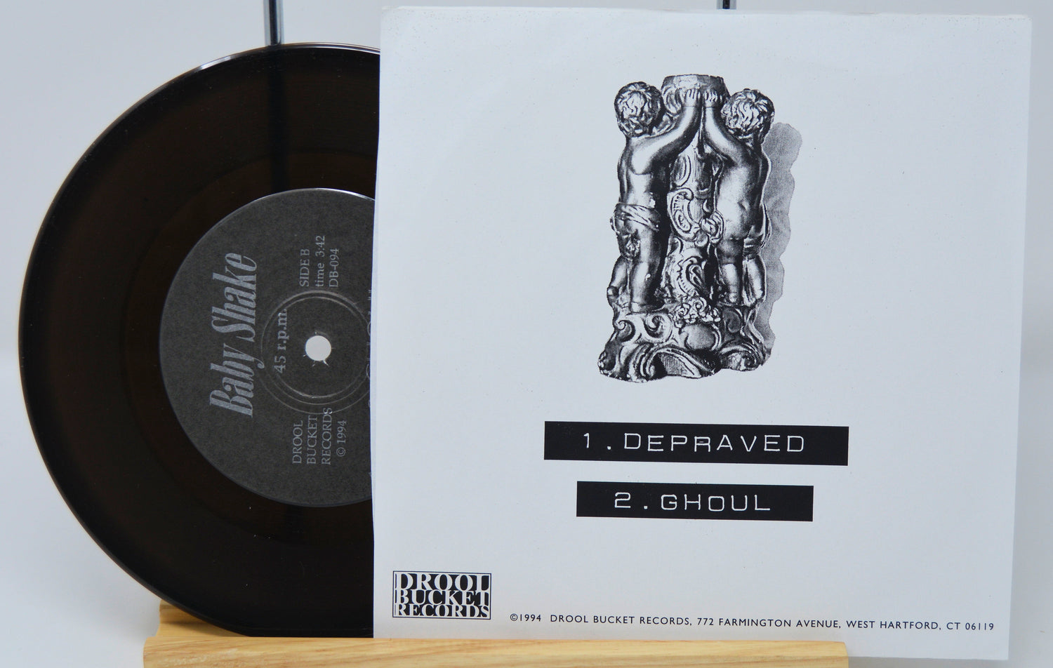 Vinyl record with cover featuring artwork and text on a white background