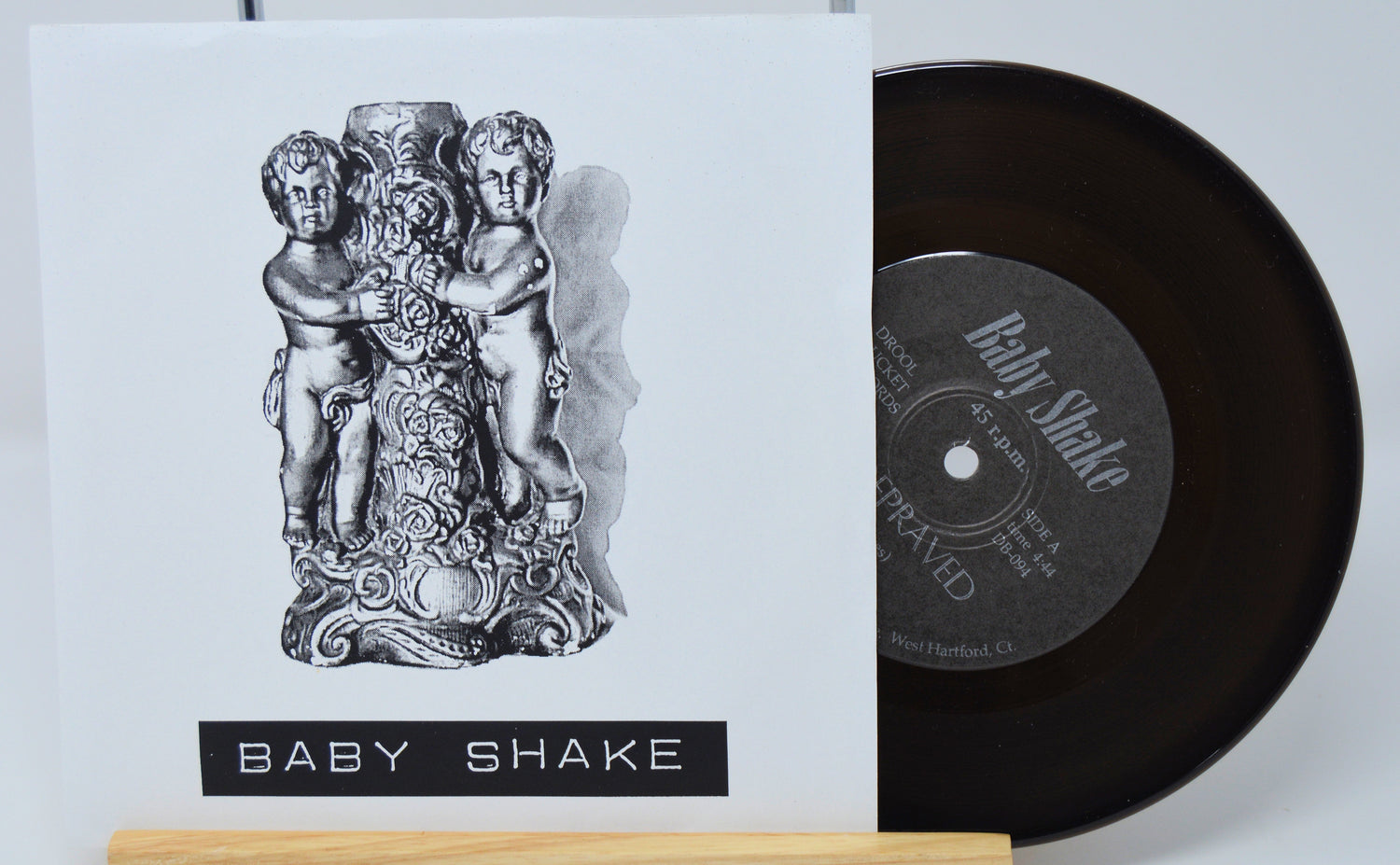 Vinyl record with cover featuring 'Baby Shake' design on a white background
