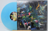 Back cover and azure blue vinyl of Martin Gore's The Third Chimpanzee EP, featuring abstract colorful artwork