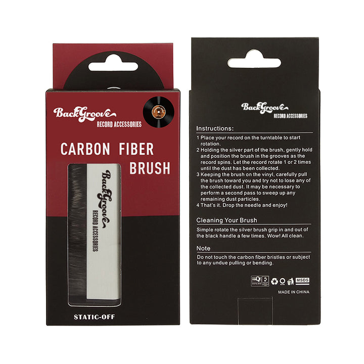 Packaging of Backgroove Audio Carbon Fiber Record Brush, featuring the brush itself with a carbon fiber body and a white label, placed within a red and black box with product information.