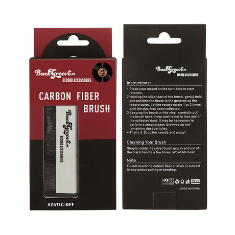 Packaging of Backgroove Audio Carbon Fiber Record Brush, featuring the brush itself with a carbon fiber body and a white label, placed within a red and black box with product information.