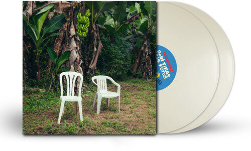 Vinyl record with a cover featuring two white chairs and banana trees in the background.