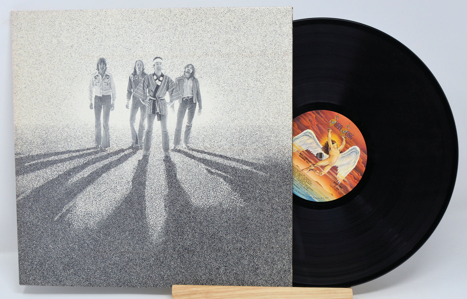 A vinyl record titled 'Burnin' Sky' by Bad Company with a black and white cover art featuring the band members.
