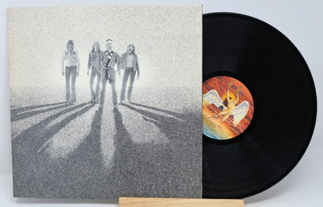 A vinyl record titled 'Burnin' Sky' by Bad Company with a black and white cover art featuring the band members.