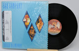 Vinyl record with a blue cover featuring artistic designs and text.