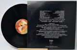Vinyl record with cover displaying tracklist and artwork on a white background