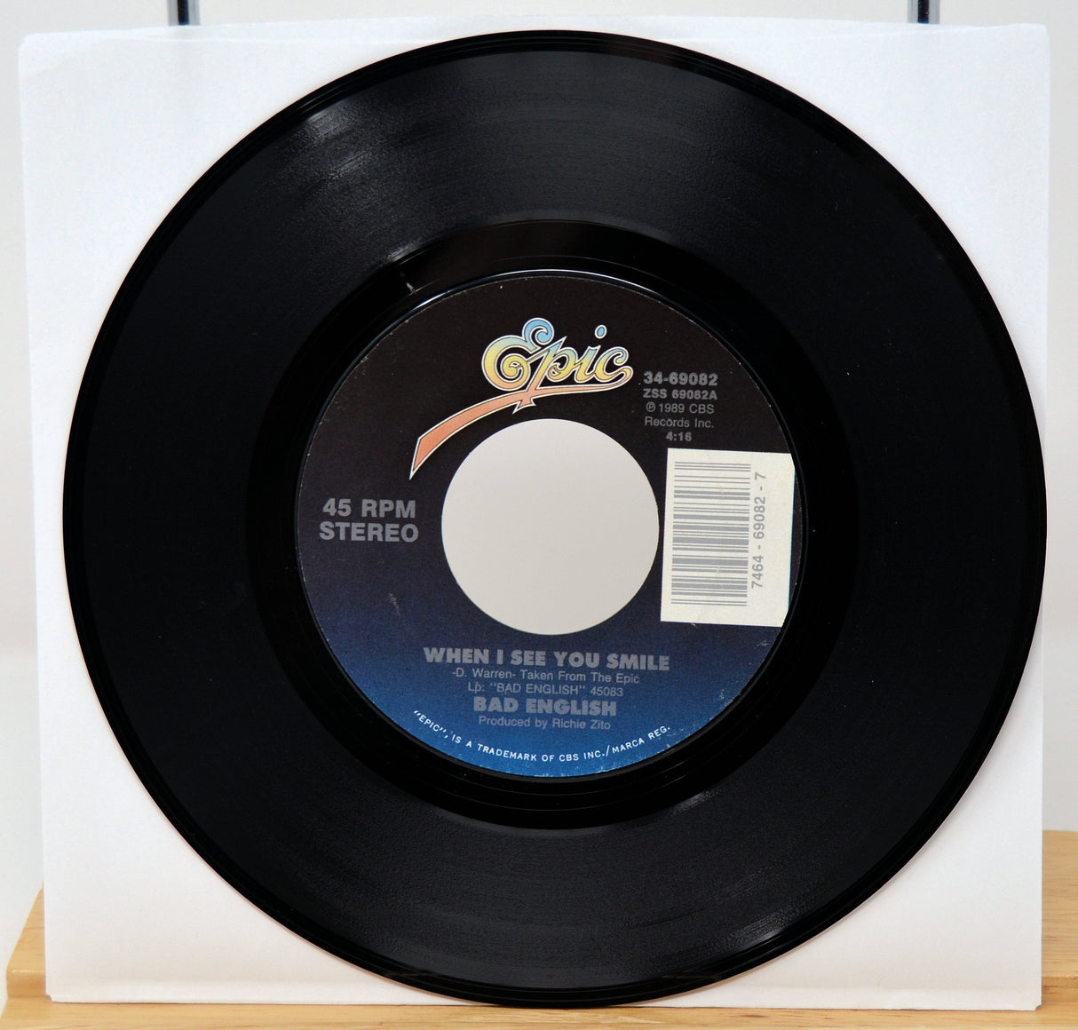 Black vinyl record with a label on a white background