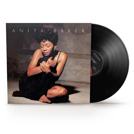 Vinyl record with cover featuring a woman sitting on the ground, titled 'Rapture' by Anita Baker.