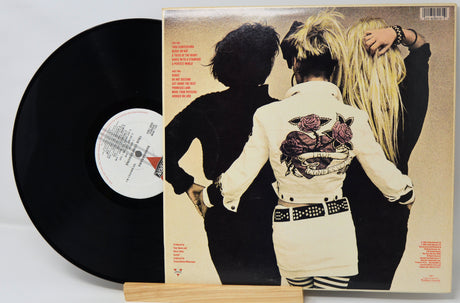 Vinyl record with a cover featuring two people holding hands on a beige background