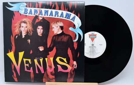 Vinyl record with 'Bananarama Venus' cover featuring three people against a red background.