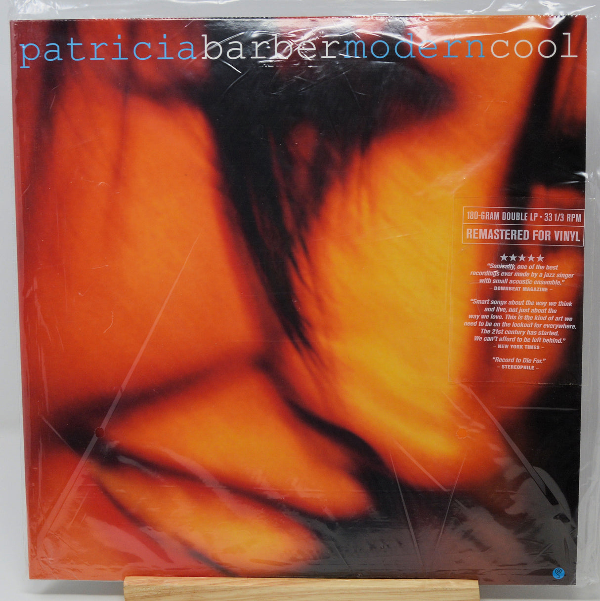 Patricia Barber's 'Modern Cool' 12-inch vinyl record double LP cover, sealed in its original plastic shrink wrap and displayed on a small wooden stand.
