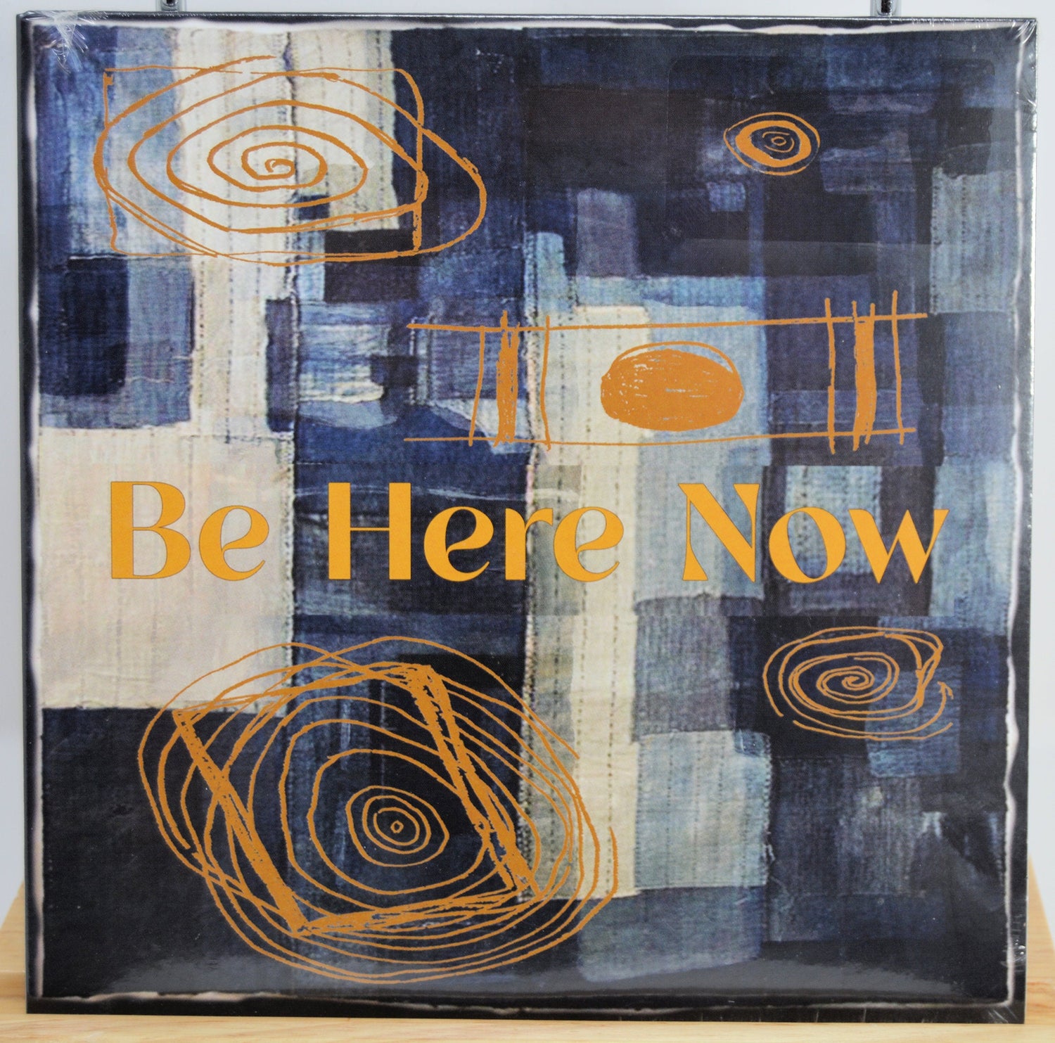 Front cover of Be Here Now vinyl with abstract blue and orange artwork and title
