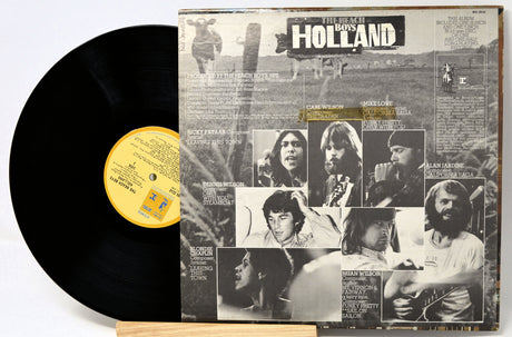Vinyl record Holland by the Beach Boys with its back cover featuring black and white images of a band and text.