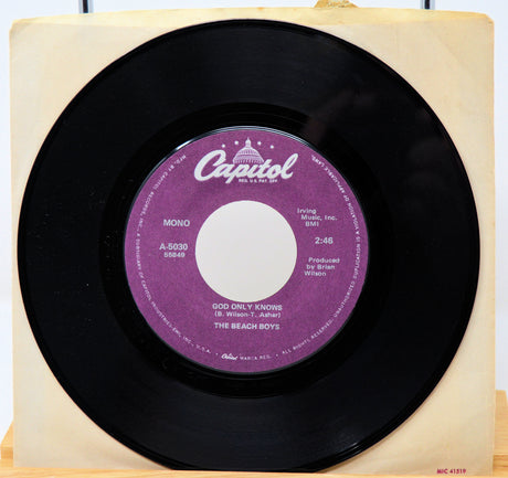 45 RPM record with a purple label on a wooden stand