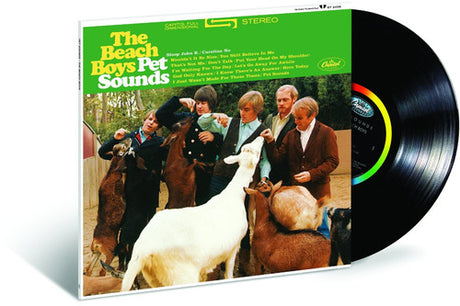A vinyl record album of 'Pet Sounds' by The Beach Boys with a colorful cover featuring the band members and goats.