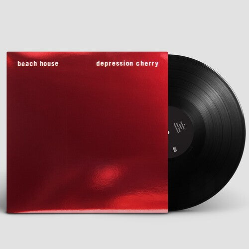 Vinyl record with a red cover titled 'depression cherry' by beach house on a light gray background