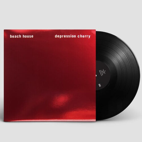 Vinyl record with a red cover titled 'depression cherry' by beach house on a light gray background