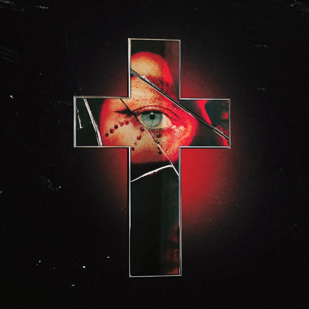 Cross-shaped mirror with a cracked surface reflecting an eye on a black background