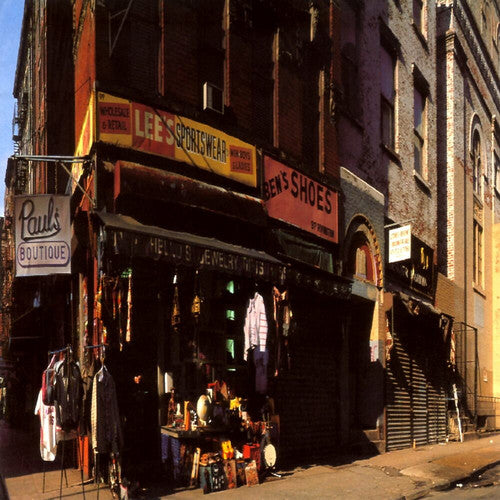 An album cover featuring a vinyl record with the Beastie Boys - Paul's Boutique. The image depicts a street scene with shops and people in the background.