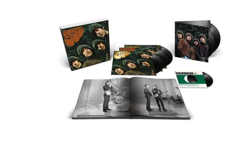 A music album set displayed on a white background, including a square cover with band portraits, a stack of black vinyl records, an open book or booklet with black-and-white photos, a smaller square insert, and a green-and-white record sleeve.