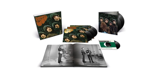 A music album set displayed on a white background, including a square cover with band portraits, a stack of black vinyl records, an open book or booklet with black-and-white photos, a smaller square insert, and a green-and-white record sleeve.