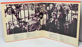 Album cover with black and white photos of people behind bars, featuring a child in the center.