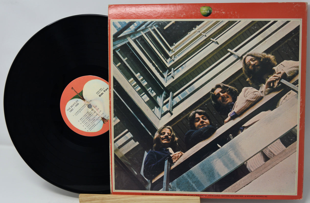Vinyl record with cover featuring a group of people on a staircase