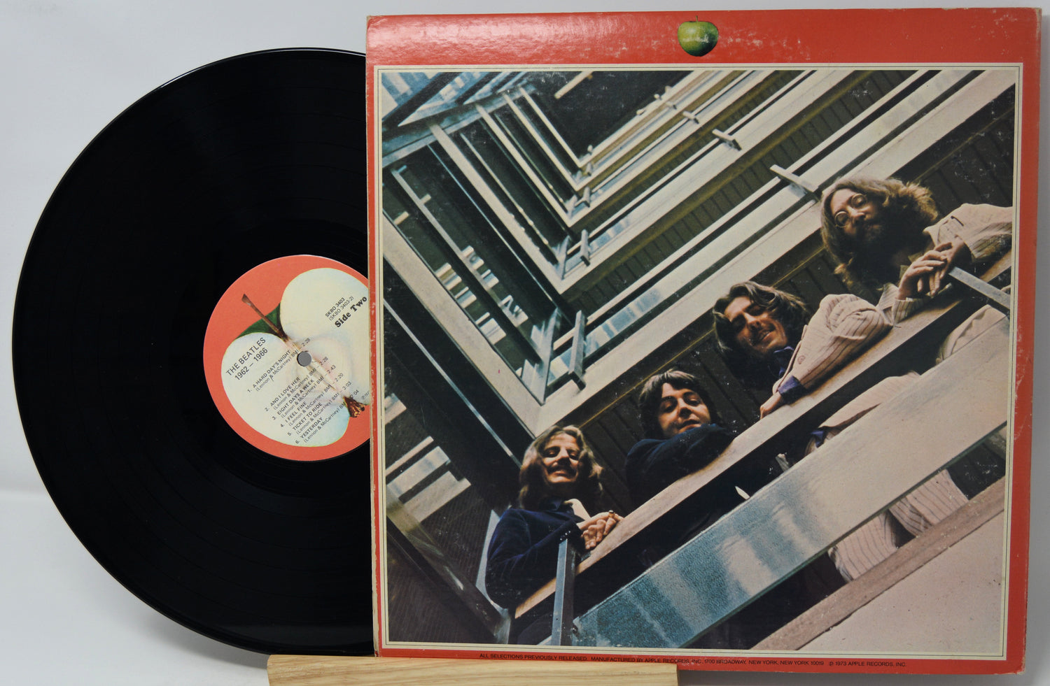 Vinyl record with cover featuring a group of people on a staircase
