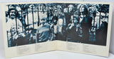 Album cover with black and white photos of people behind bars and text on a white background