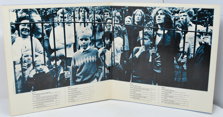 Album cover with black and white photos of people behind bars and text on a white background