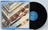 Vinyl record and cover of 'The Beatles 1967-1970' on a white background