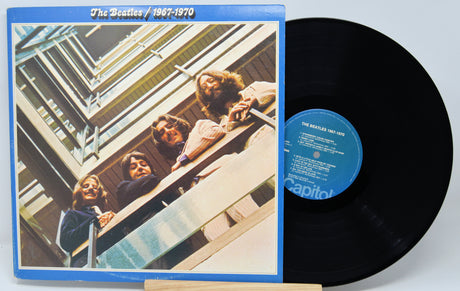 Vinyl record and cover of 'The Beatles 1967-1970' on a white background