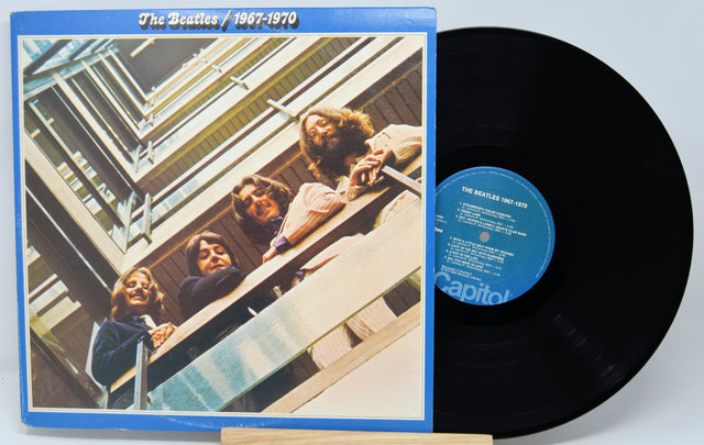 Vinyl record and cover of 'The Beatles 1967-1970' on a white background