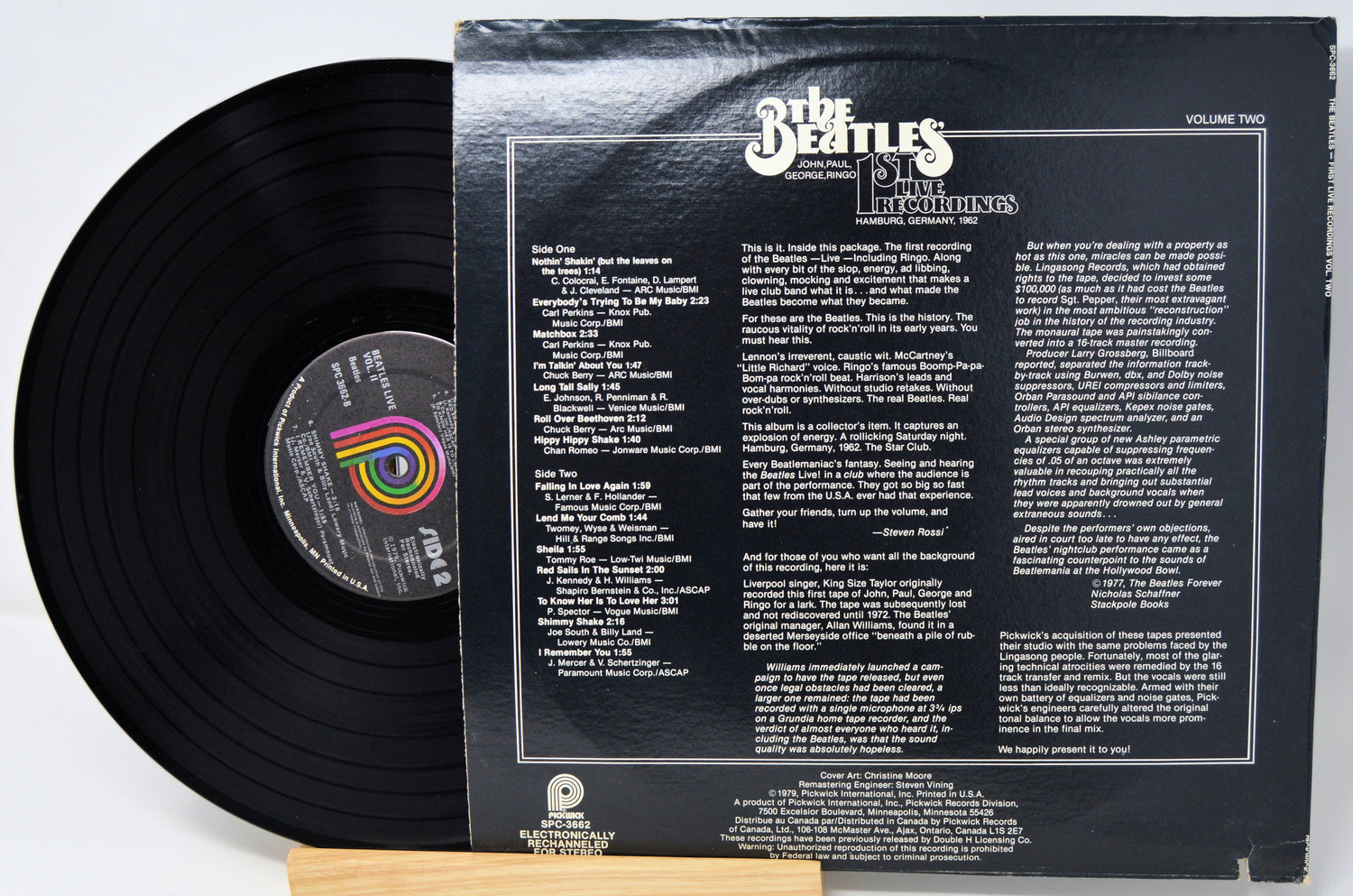 Vinyl record with a detailed cover featuring text and graphics, on a white background.
