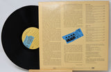 Vinyl record with cover displaying text and a blue label on a white background