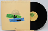 Vinyl record and cover with 'The Beatles at the Hollywood Bowl' on a white background