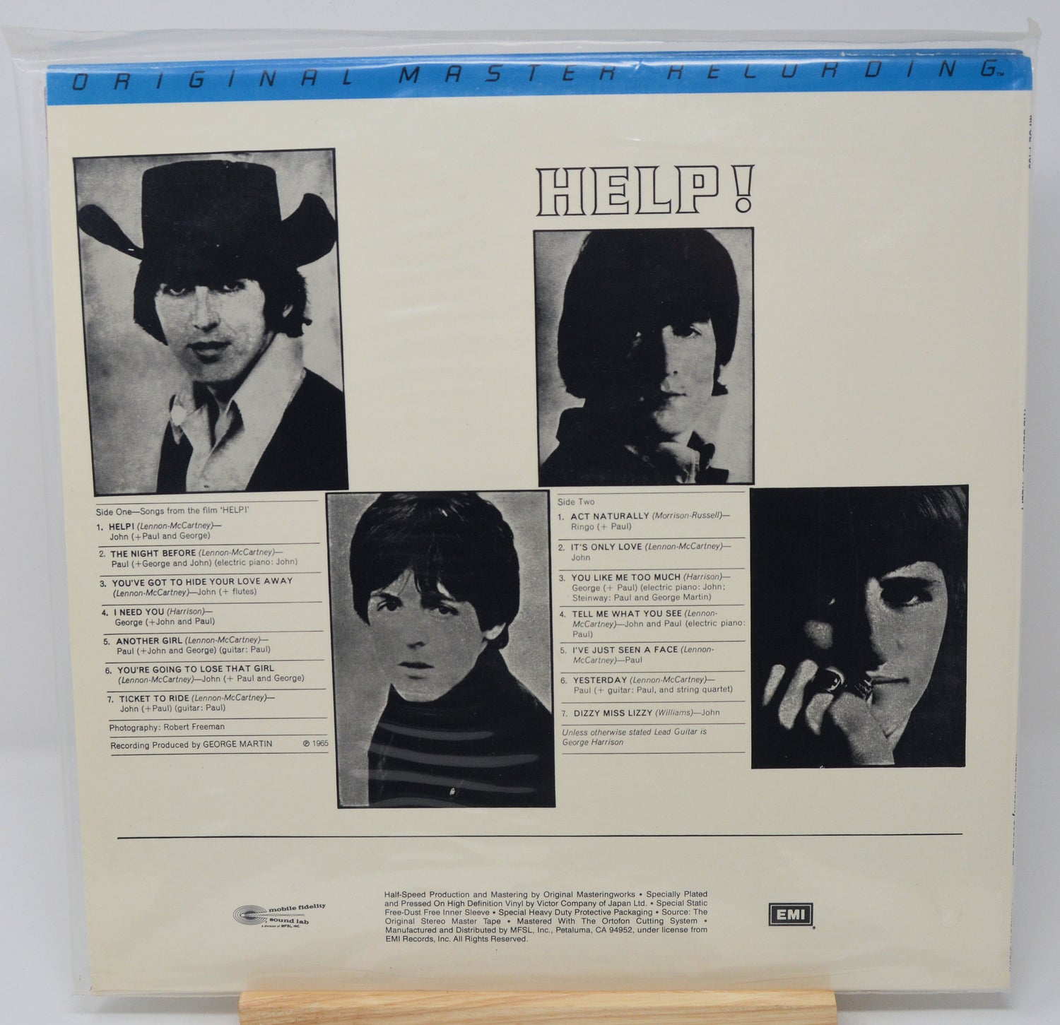 Back cover of a vinyl record with black and white photos and text, featuring the title 'Help!' by The Beatles.