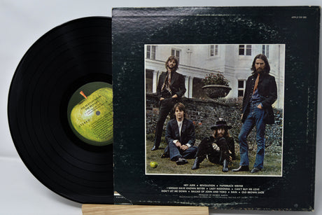Vinyl record with cover featuring a group of people outdoors.