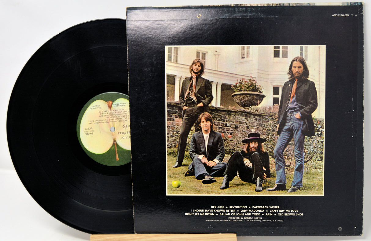 Vinyl record with cover featuring a group of people outdoors.