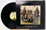 Vinyl record with cover featuring a group of people outdoors.