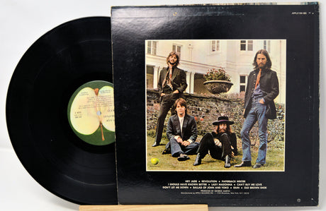 Vinyl record with cover featuring a group of people outdoors.