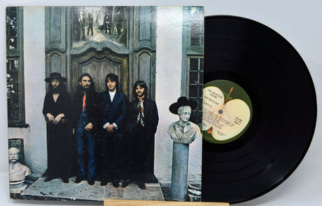 Vinyl record with cover featuring a group of people and an apple logo.