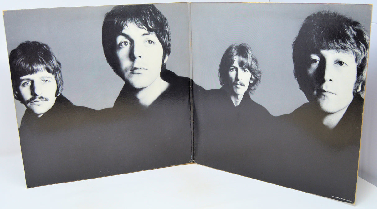 Album cover with black and white portraits of four band members on a gray background