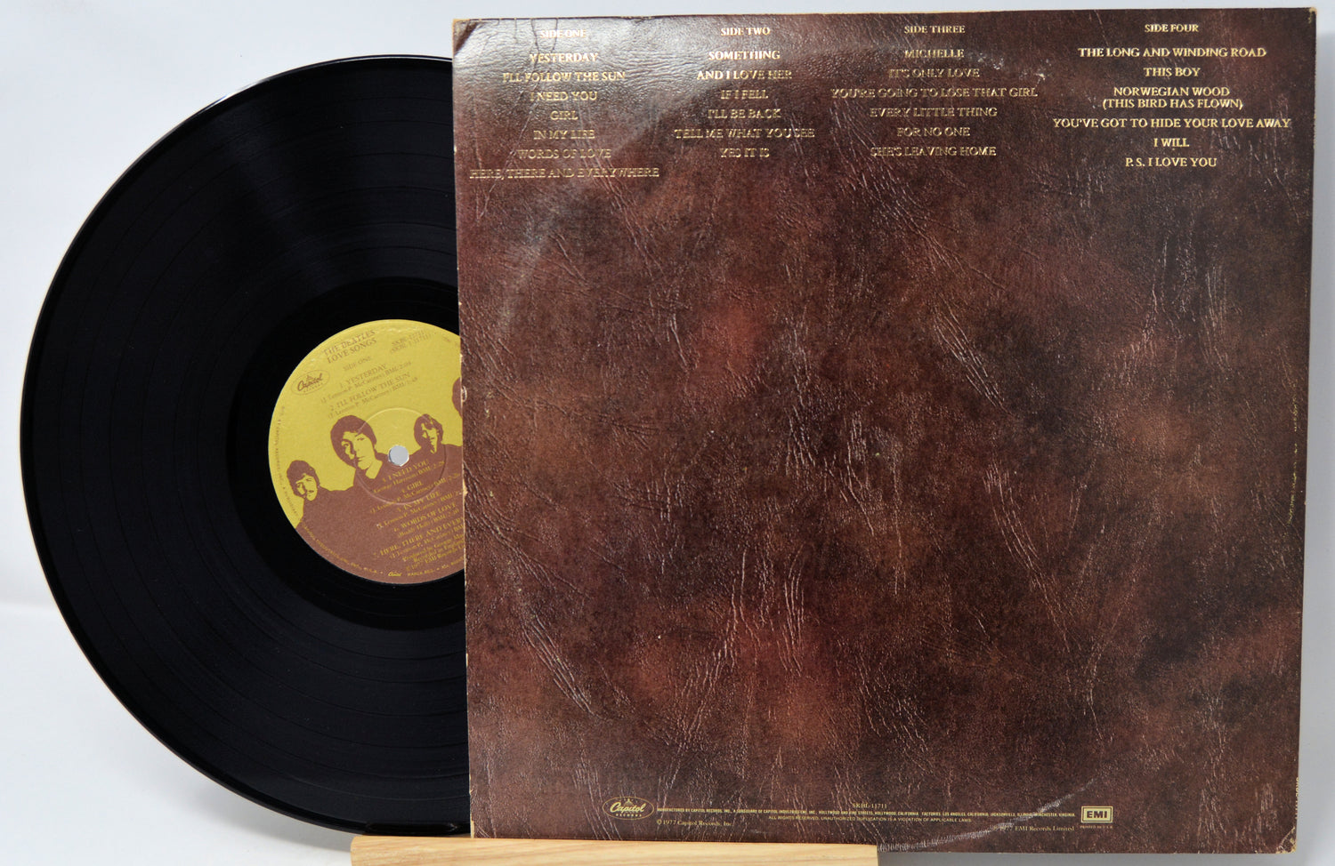 Vinyl record with a brown textured cover and yellow label featuring a band's logo.