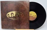 Vinyl record and cover with 'The Beatles' artwork on a white background
