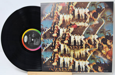 Vinyl record with a colorful cover featuring people on a staircase.